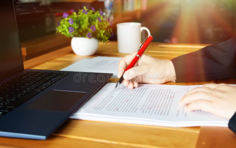 Draft editing workspace with laptop and printed academic pages